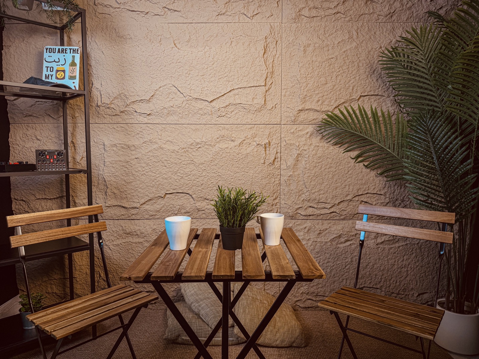 Casual stone-wall corner with bistro table and seating